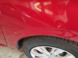 a close up of a red car with a flat tire