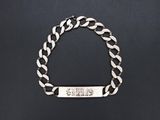 a silver bracelet with a bar on it