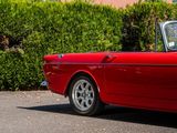 an image of a red convertible car parked on the street