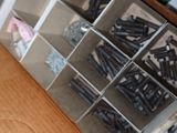 a box of screws and nuts on a table