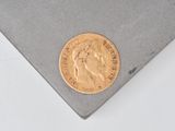an image of a gold coin sitting on top of a piece of paper