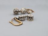 a close up of a pair of earrings on a table