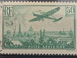 an old stamp with a picture of a plane flying over a city