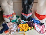 three mannequins in front of a display of underwear