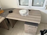 a desk with a chair and a computer on it