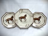 three plates with horses painted on them on a white background