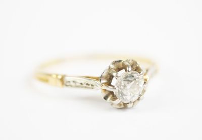 a close up of a diamond engagement ring on a white background