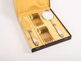 a box with silverware in it on a white surface