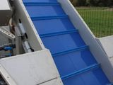 a blue ramp going down the side of a building