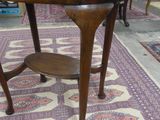 an oval table with a wooden top on a rug in a room