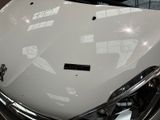 a close up of a white car with its hood up