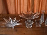 several pieces of glass sitting on top of a wooden table