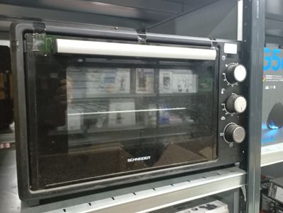 a black toaster oven sitting on top of a shelf in a store