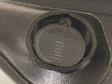 a close up of a metal object with a button on it