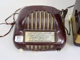 two old fashioned radio ' s sitting on a table next to each other
