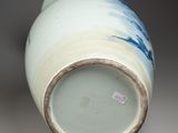 a blue and white vase sitting on a table