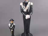 figurine of a man in a uniform and a man in a hat
