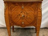 a wooden chest of drawers sitting on top of a floor