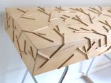 a wooden table with a metal base and a pattern on it