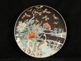 an image of a decorative plate with a bird and flowers on it