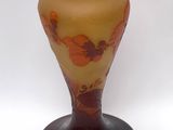 a glass vase with a yellow and red design on it