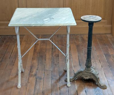 a small table and a small stool on a wooden floor