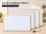 un ensemble de quatre tableaux blancs posés sur une table en bois, avec un marqueur
