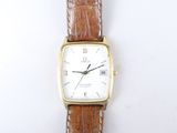 a close up of a watch on a white surface