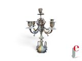 a silver candelier with three candles on it