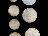 an image of a group of five different coins on a black background