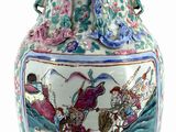 a large vase with a painting on it sitting on a table