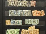 many different stamps on display in a glass case