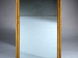 an image of a gold framed mirror against a gray background