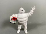 a small toy figure of a man holding a camera