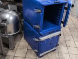 a blue cooler sitting on the floor in a kitchen