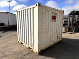 a white container sitting in the middle of a parking lot