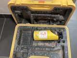 une mallette à outils jaune posée par terre, contenant une bouteille
