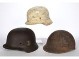 three helmets are sitting on top of a white surface