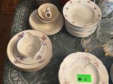 a table with a lot of dishes and cups on it