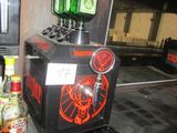 a beer dispenser sitting on a counter next to bottles