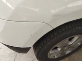 a close up of a white car with black rims