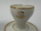 a cup and saucer on a saucer on a white table