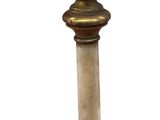 a small pedestal with a clock on top of it