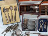 a box of silverware and other silverware on a table