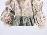 an image of a child ' s blouse hanging on a hanger