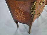 a small wooden table with a marble top on display