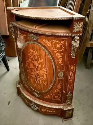 a wooden cabinet that has a mirror on top of it