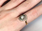 a woman ' s hand with a diamond ring on it
