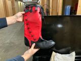 a person that is putting a boot on top of a tv