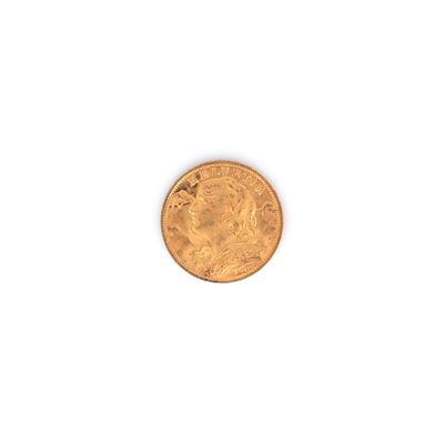 gros plan d'une pièce d'or sur une surface blanche
